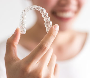 woman-holding-clear-retainer
